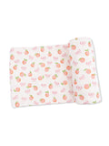 Patterned fabric featuring peaches and bows in soft pastel colors.