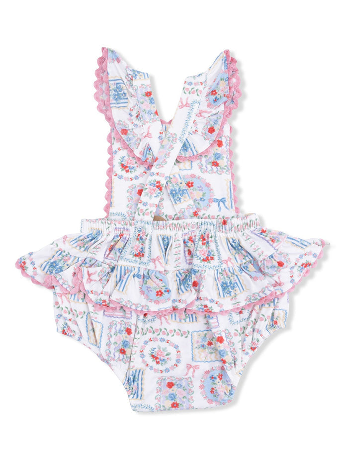 Floral print swimsuit with ruffles and lace, featuring crisscross straps and a playful design for children.