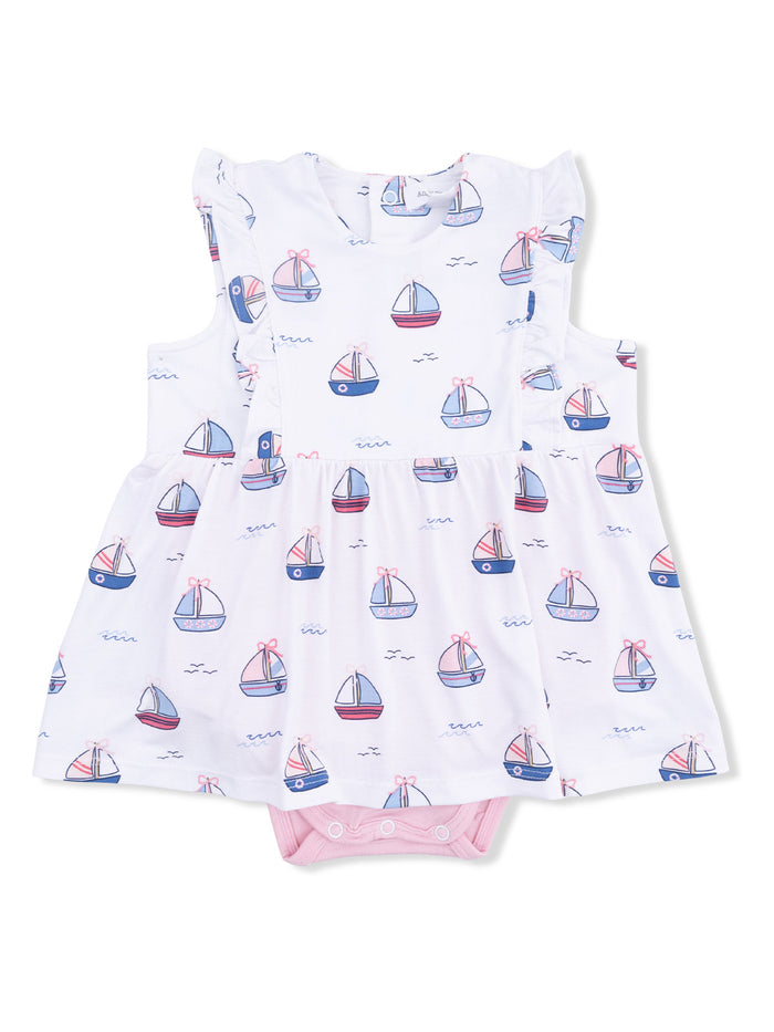 White dress with sailboat pattern, ruffled sleeves, and pink bottom snap closure for infants.