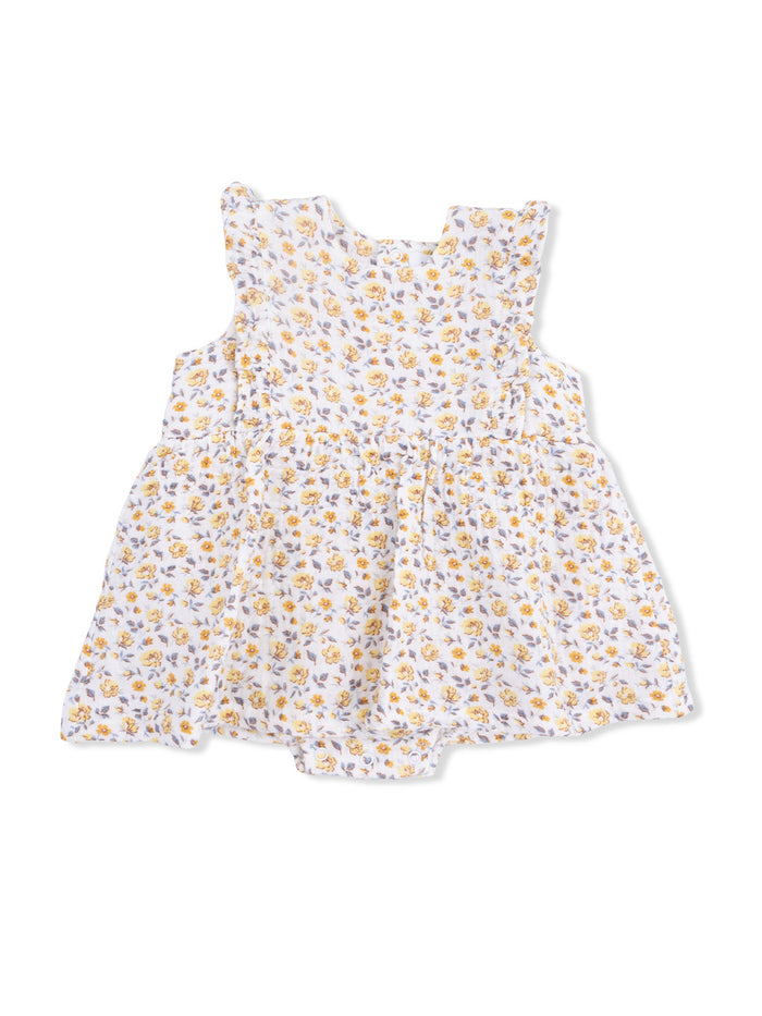 White dress with yellow and purple floral pattern and ruffled sleeves, designed for young children.