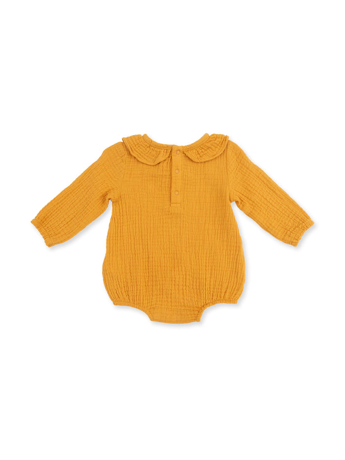 Mustard yellow baby romper with a collar and long sleeves, featuring a button placket in front.