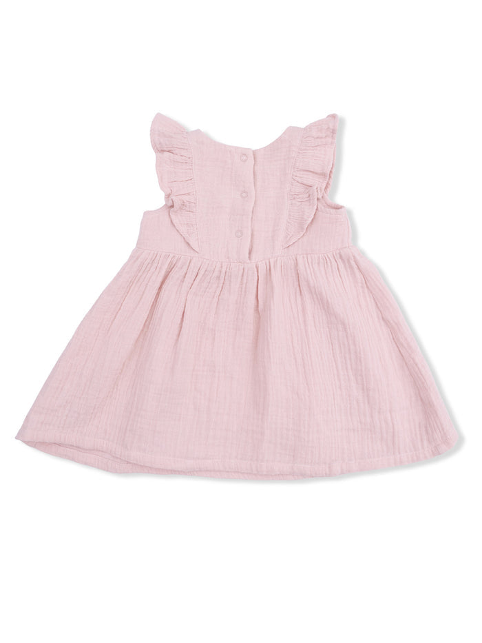 Light pink dress with ruffled sleeves and button closure, featuring a flowy skirt.