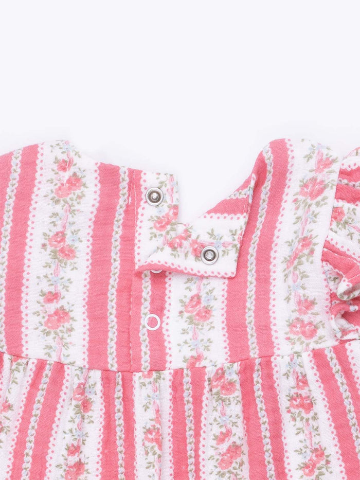 Pink and white striped dress with floral pattern and snap closure at the shoulder.