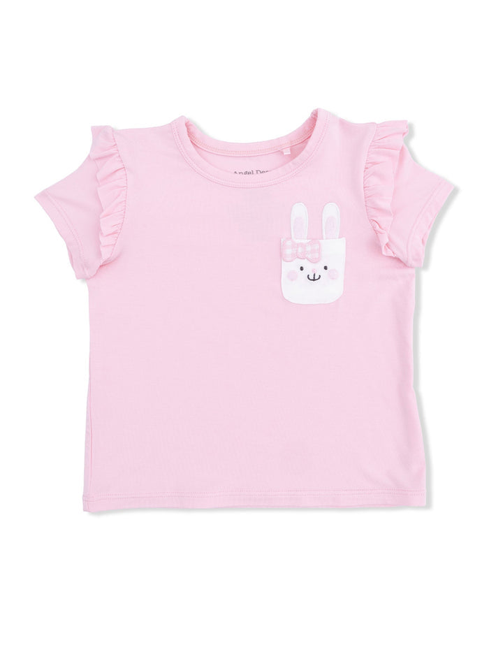 Light pink short-sleeve shirt with ruffles and a bunny pocket design. Ideal for children’s casual wear.