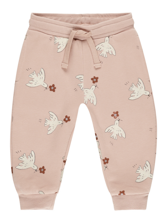 Pink children’s sweatpants featuring white birds and small floral patterns. Casual and comfy design.