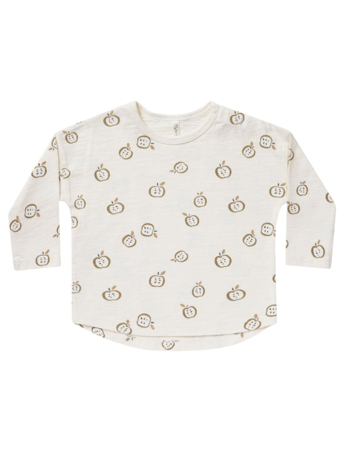 Light cream long-sleeve shirt with a playful apple print in brown and green tones.