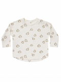 Light cream long-sleeve shirt with a playful apple print in brown and green tones.
