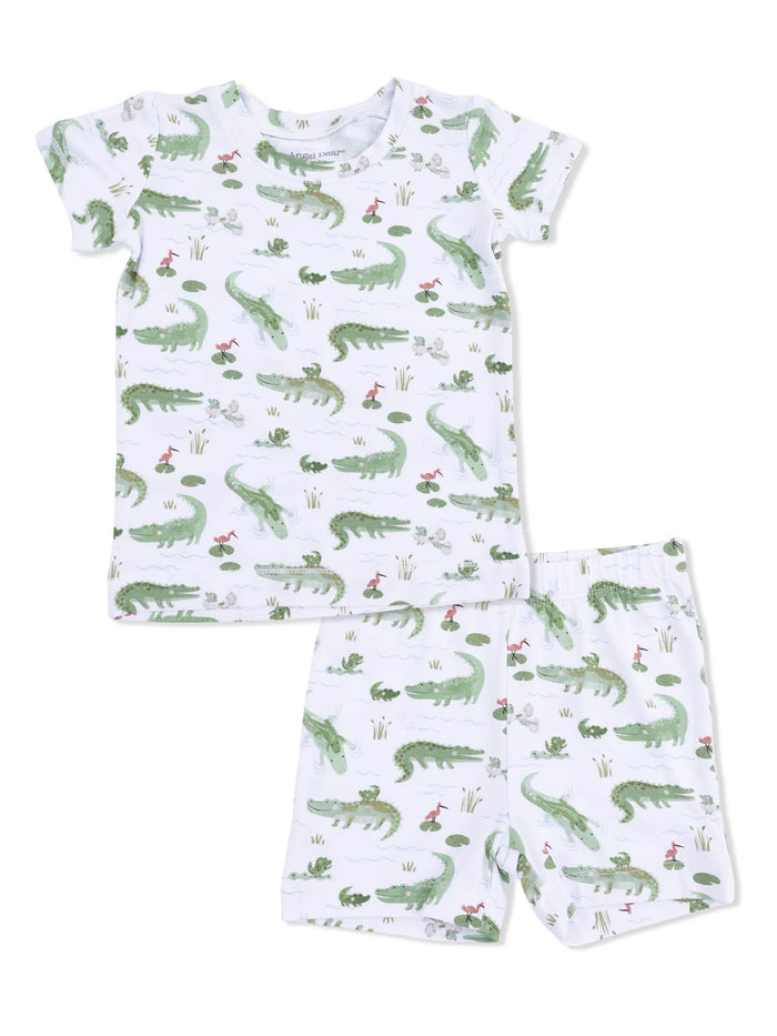 Children's pajama set featuring a playful alligator pattern on a white background.