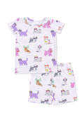 Kids' pajama set featuring colorful dog and cat illustrations on a light purple striped background.