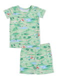 Children's green pajama set with playful golf-themed graphics of animals and nature. Short-sleeve top and shorts.