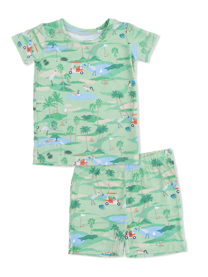 Children's green pajama set with playful golf-themed graphics of animals and nature. Short-sleeve top and shorts.