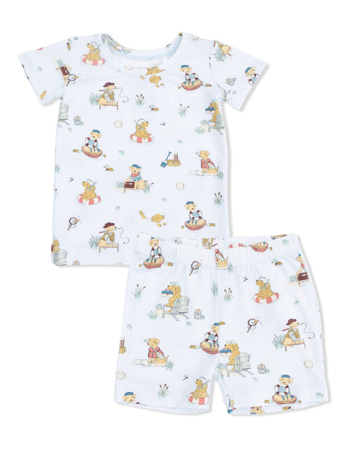 Children's pajama set featuring playful dog illustrations on a light background. Includes a shirt and shorts.