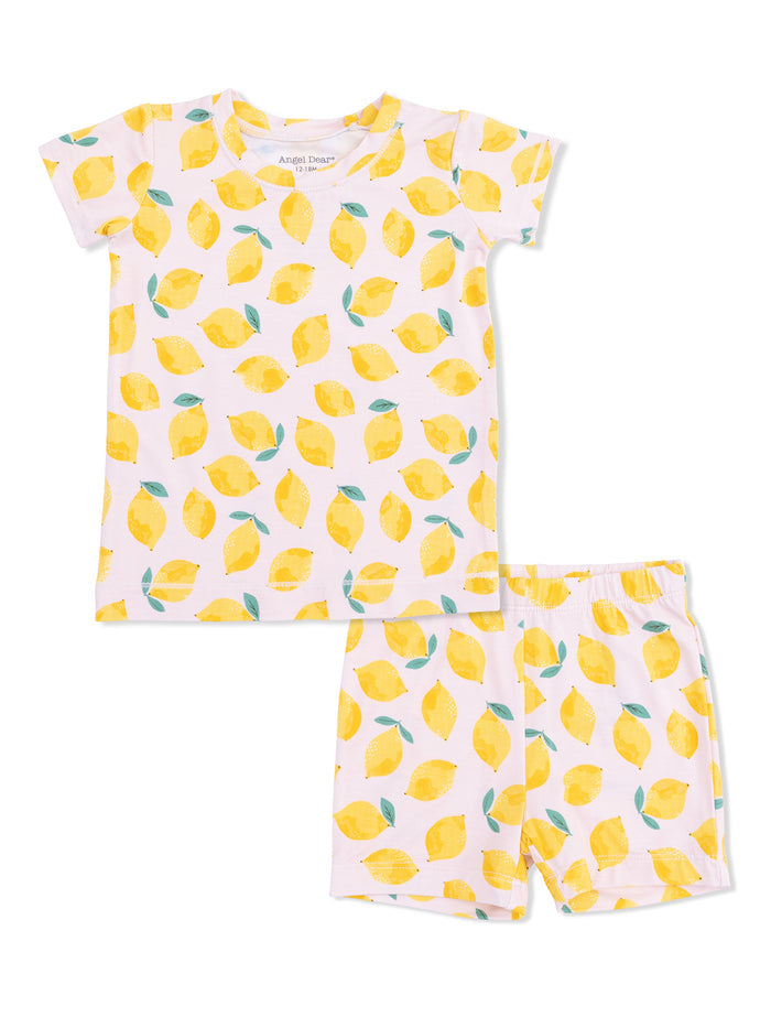 Lemon-patterned children's pajama set featuring a short-sleeve top and shorts on a pink background.