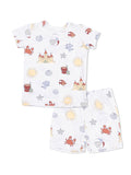 Children's beach-themed pajama set featuring castles, crabs, suns, and sea creatures on a white background.