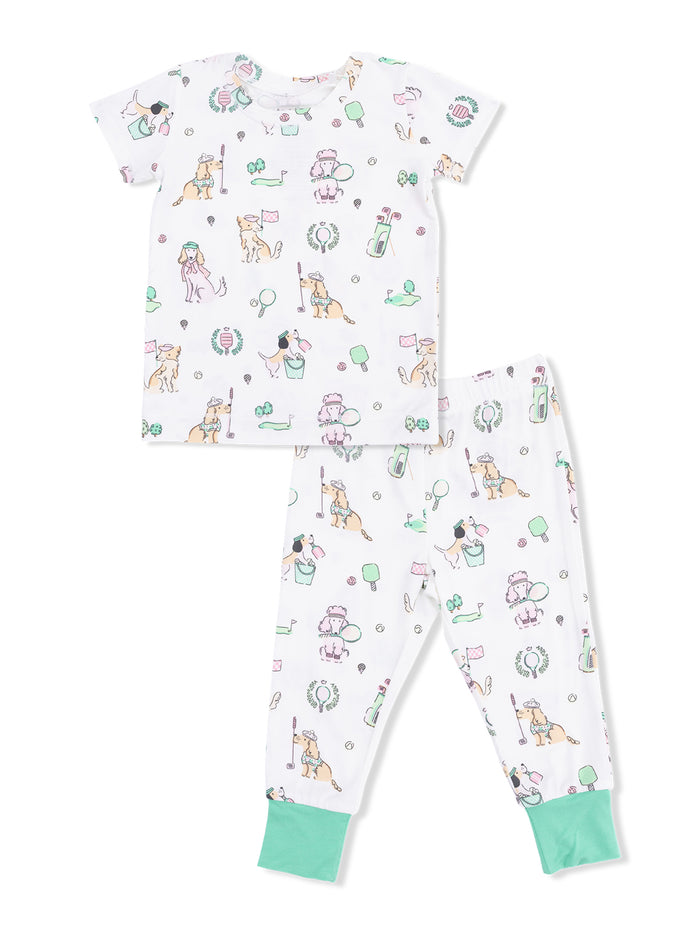 Children's pajama set featuring playful dog prints, including golf, ice cream, and balloons on a white background.