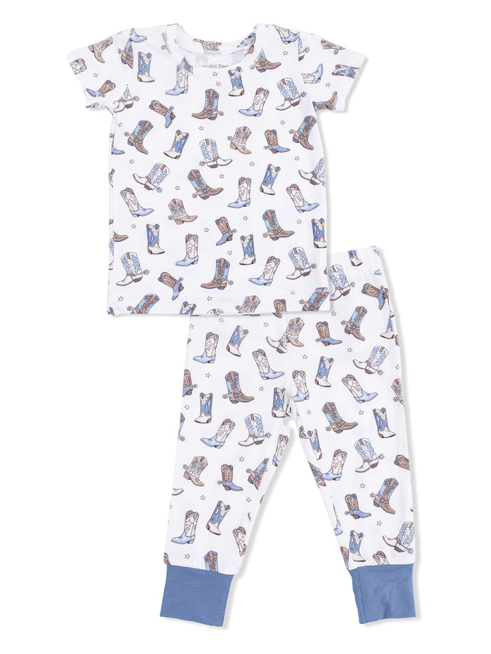 Child's pajama set featuring a white fabric with colorful cowboy boots patterns on a short-sleeve top and pants.