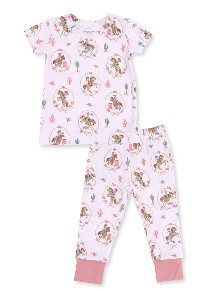 Pink children's pajama set featuring playful horse-themed prints and floral designs, including a short-sleeve top and pants.