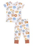 Children's pajama set featuring cowboy-themed graphics on a white background with matching pants.