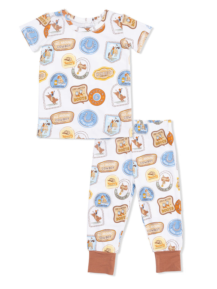 Children's pajama set featuring cowboy-themed graphics on a white background with matching pants.