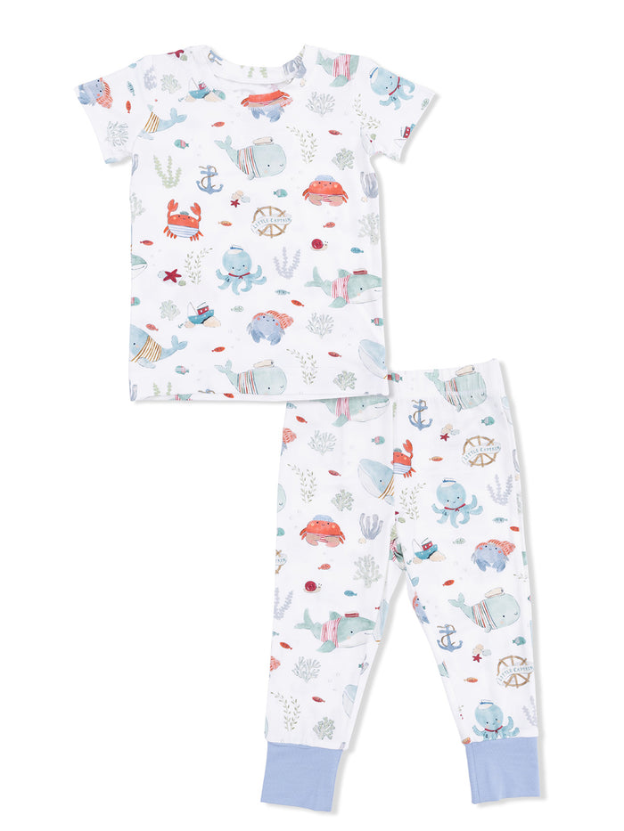 Children's pajama set featuring playful marine animal designs in soft colors, including crabs, whales, and octopuses.