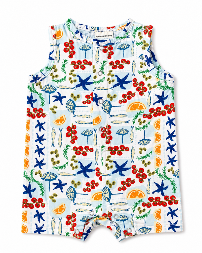 Colorful children's romper featuring a beach-themed pattern of umbrellas, starfish, and citrus fruits.