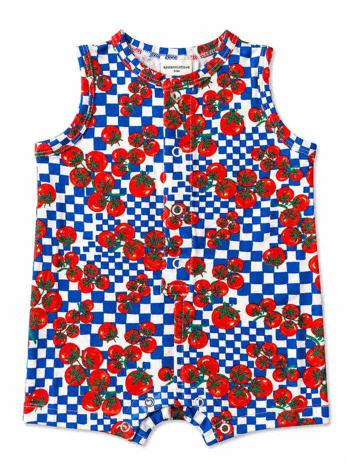 Colorful baby romper featuring red tomatoes on a blue and white checkered background.