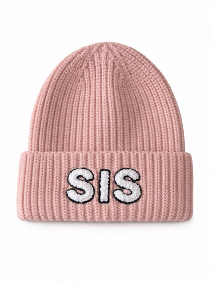 Pink knit beanie with "SIS" embroidered in white letters on the folded cuff.
