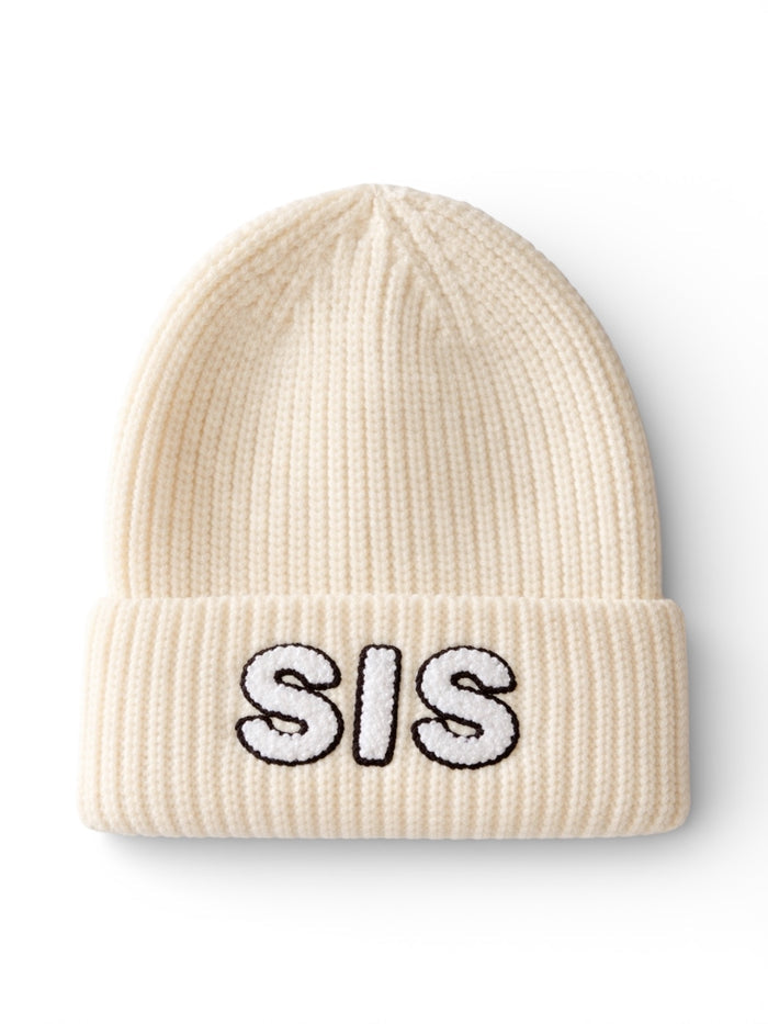 Cream-colored knit beanie with "SIS" embroidered in black and white on the front.