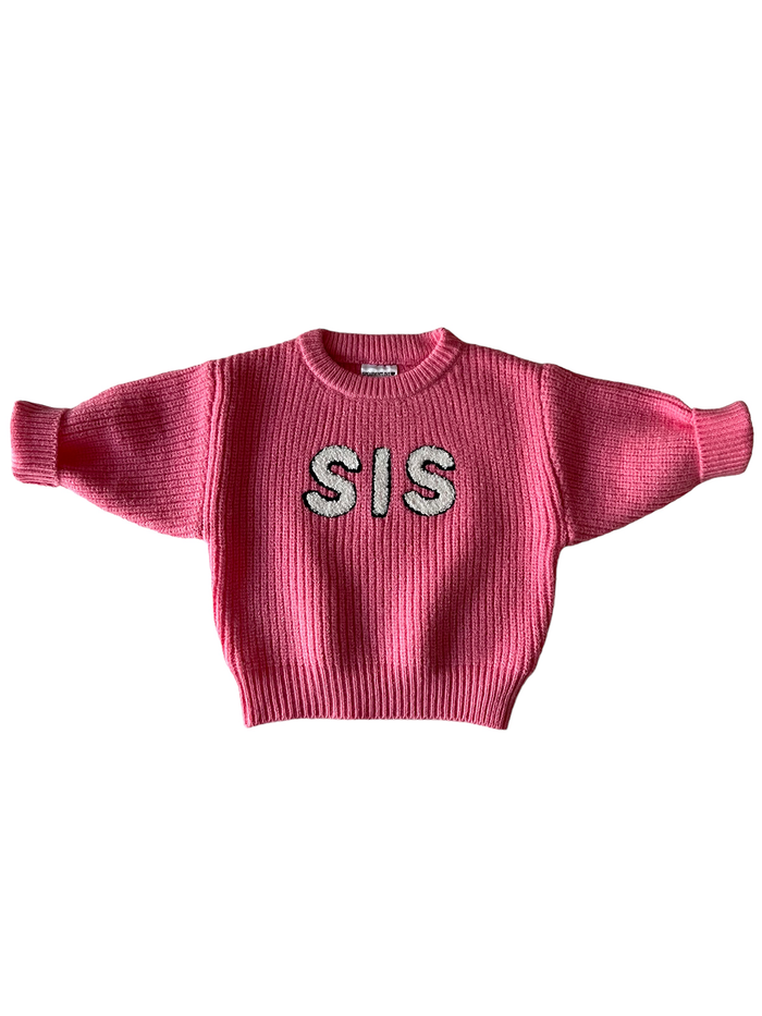 Pink sweater with ribbed texture and "SIS" lettering in white on the front.