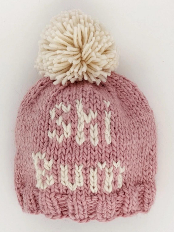 Knitted pink winter beanie with a pom-pom and "CHI WIT" text in white.