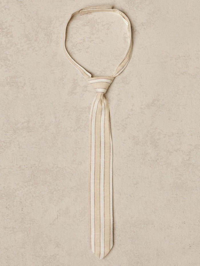 Beige striped tie displayed on a textured background.