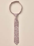Floral patterned tie hanging against a neutral background, showcasing delicate leaves and blossoms.