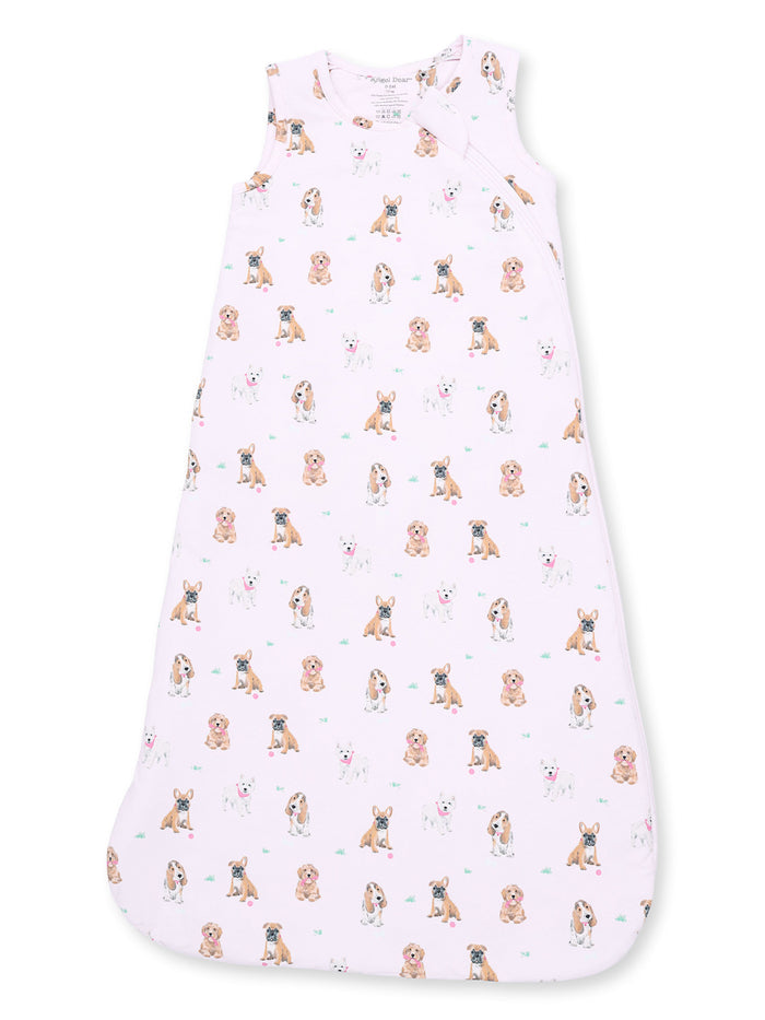 Light pink baby sleep sack with various cartoon dog patterns throughout. Ideal for comfort and safety.