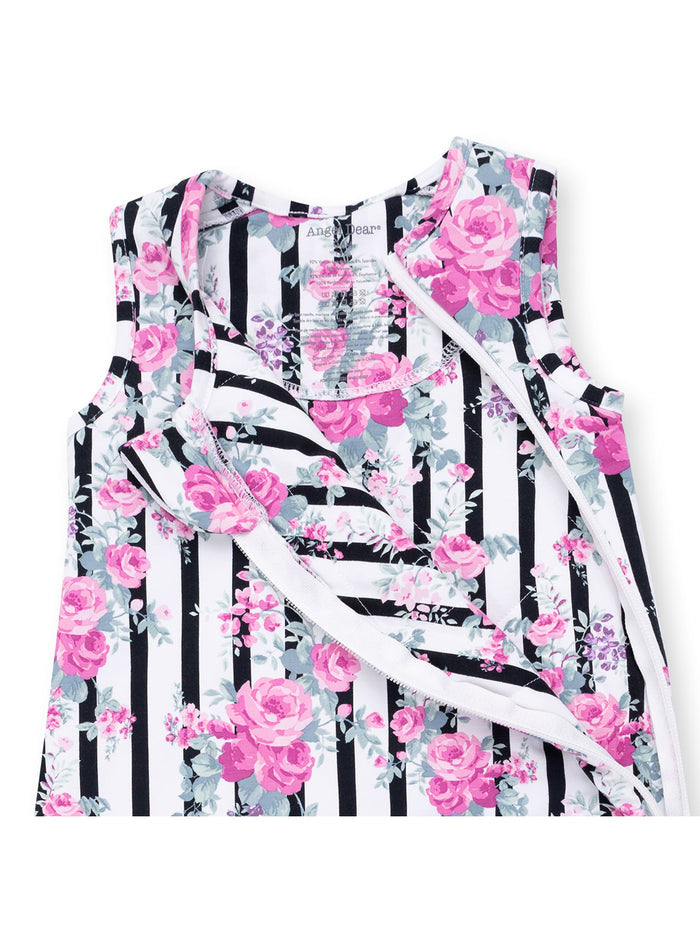 Floral dress with pink roses on black and white stripes, featuring a sleeveless design and round neckline.