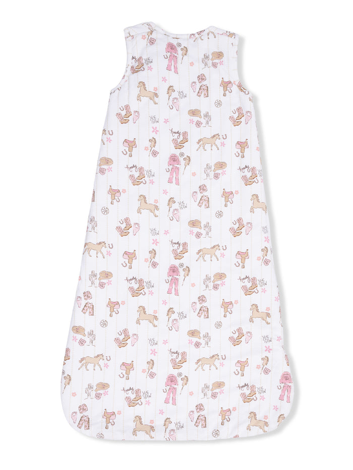 Baby sleep sack with playful horse and grooming-themed patterns in pastel colors on a white background.