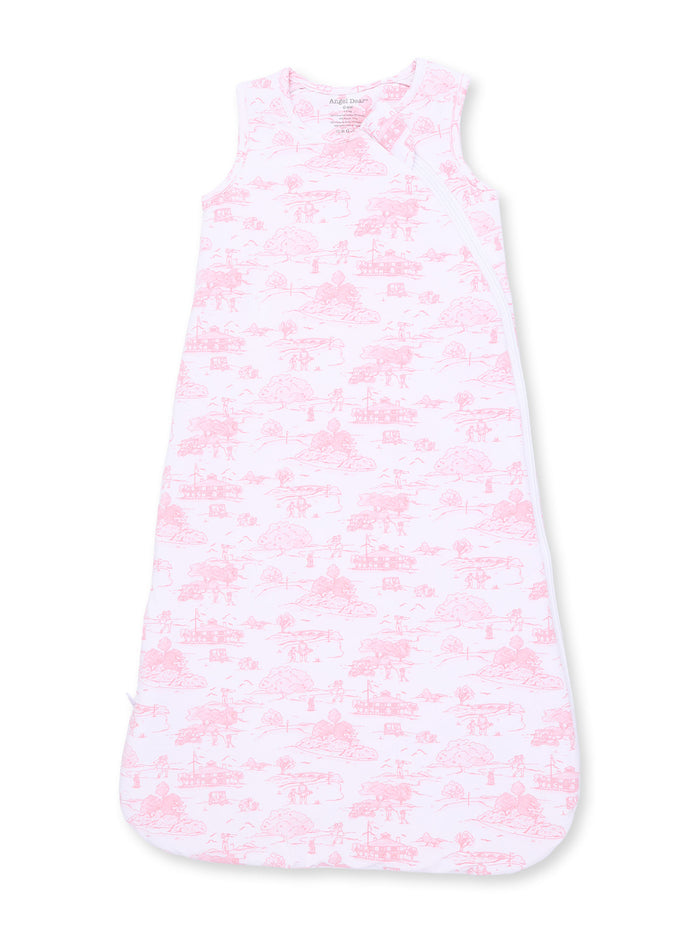Light pink baby sleeping bag with whimsical nature patterns and sleeveless design.