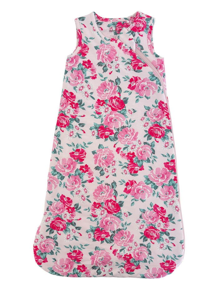 Floral baby sleeping bag in pink and white, featuring a floral pattern with roses and green leaves.
