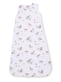 Baby sleep sack featuring a playful dog and nature print on a soft pink background. Ideal for comfort and safety.