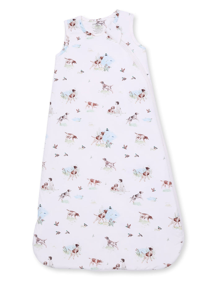 Baby sleep sack featuring a playful dog and nature print on a soft pink background. Ideal for comfort and safety.