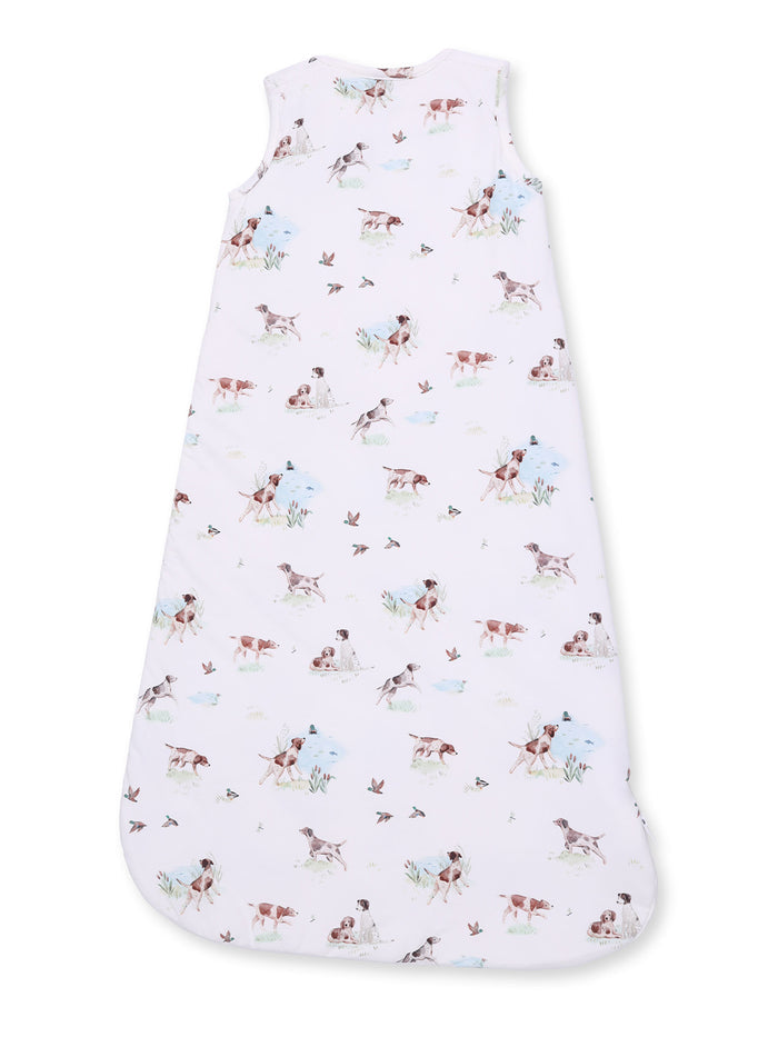 Children's sleep sack featuring a pastel print of playful dogs and birds on a white background.