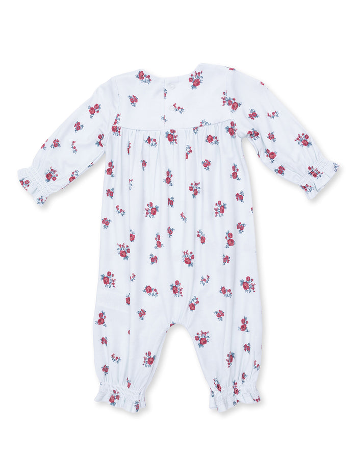 White baby romper with red and blue floral patterns and long sleeves, featuring elastic cuffs and button closure.