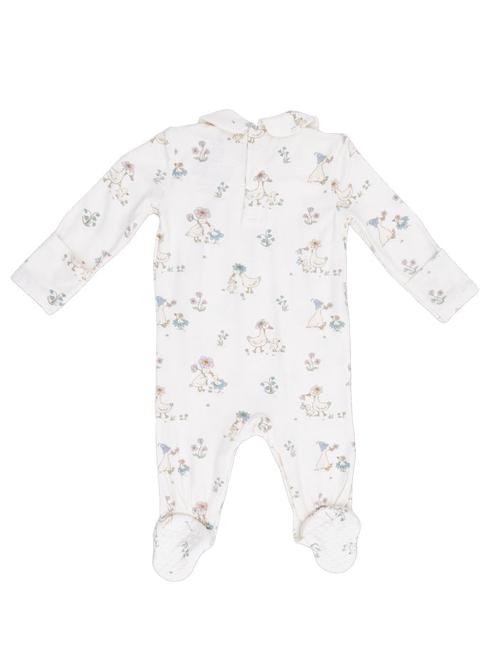 Cream-colored baby onesie with whimsical floral and animal prints, featuring long sleeves and footed design.