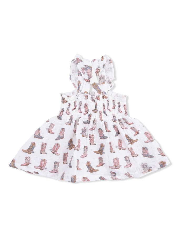 White dress with a ruffled neckline, featuring a colorful cowboy boot pattern. Ideal for casual summer wear.