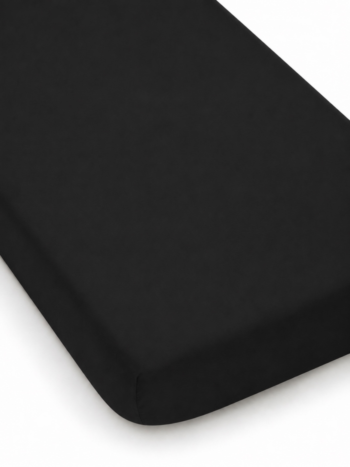 Black fitted mattress cover on a white background, showcasing soft texture and sleek design.