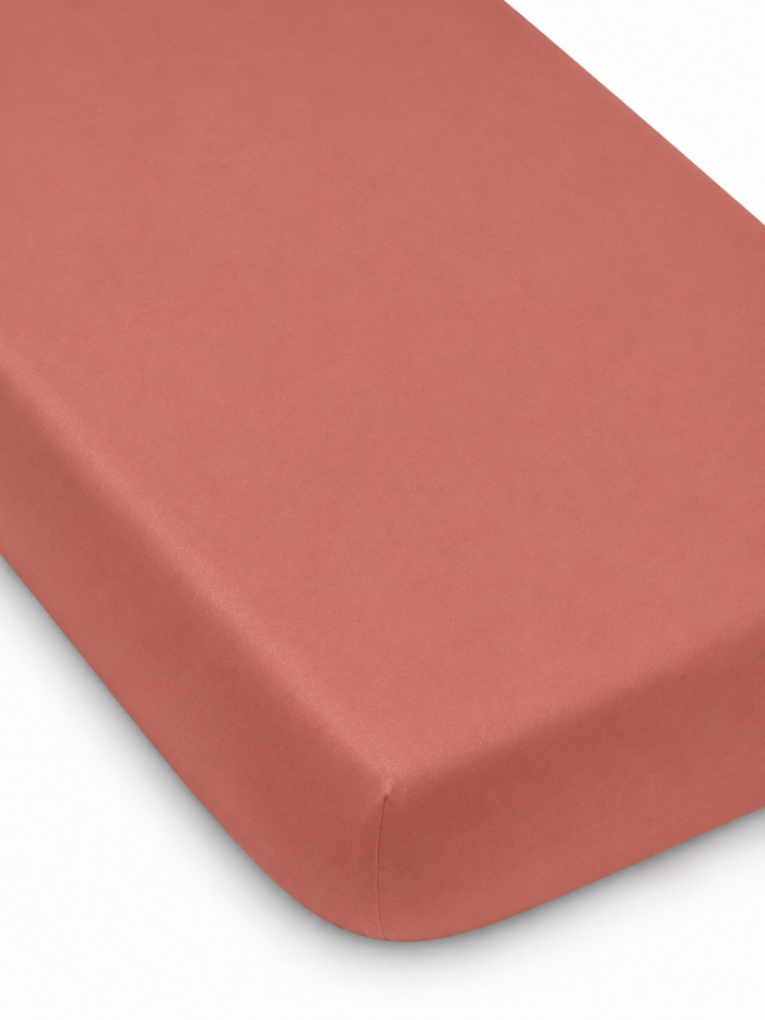 Coral rectangular mattress with a smooth surface and rounded edges. Ideal for a stylish bedding setup.