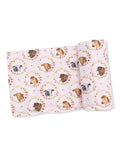 Pink fabric featuring illustrated animal heads in floral wreaths, including cows, horses, and dogs.