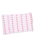 Pink fabric with football and ribbon pattern rolled neatly. Ideal for craft or sewing projects.