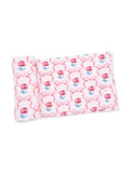Rolled fabric featuring a pink floral pattern with ribbons on a white background.