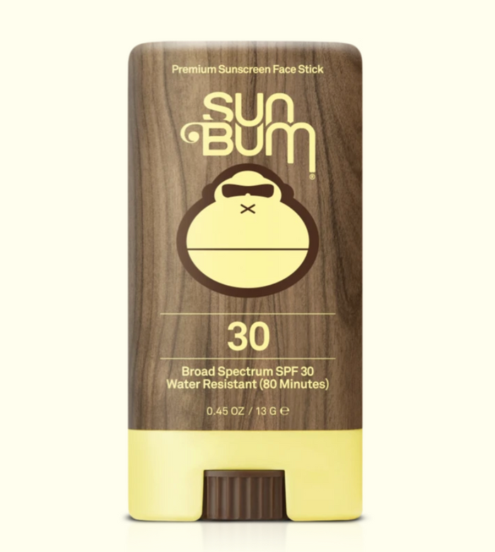 Sun Bum sunscreen face stick with wooden top and yellow base on a white background