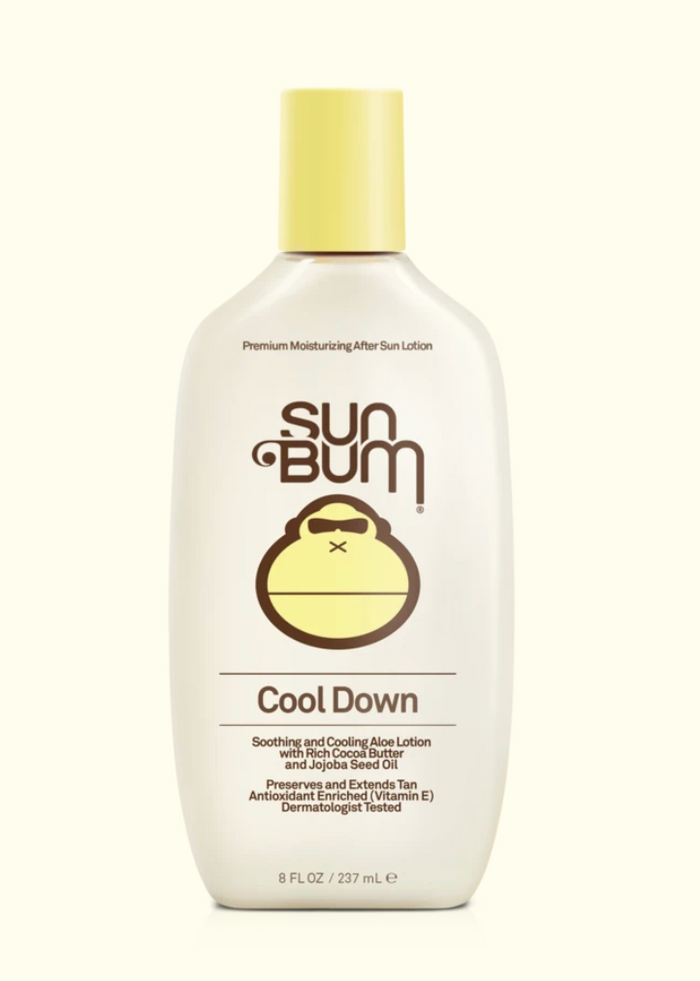 A series of four Sun Bum brand skin care products including sunscreen lotion, after sun cool down lotion, after sun cool down gel, and browning lotion, displayed outdoors.